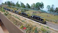 Scene with Erie engines pulling a long freight